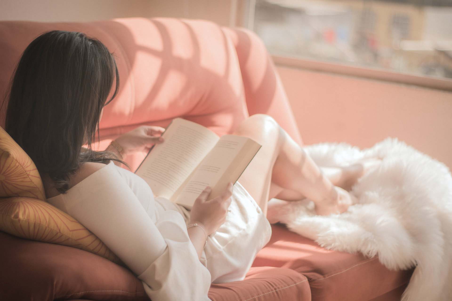 Woman reading a book, one of the acts of self care