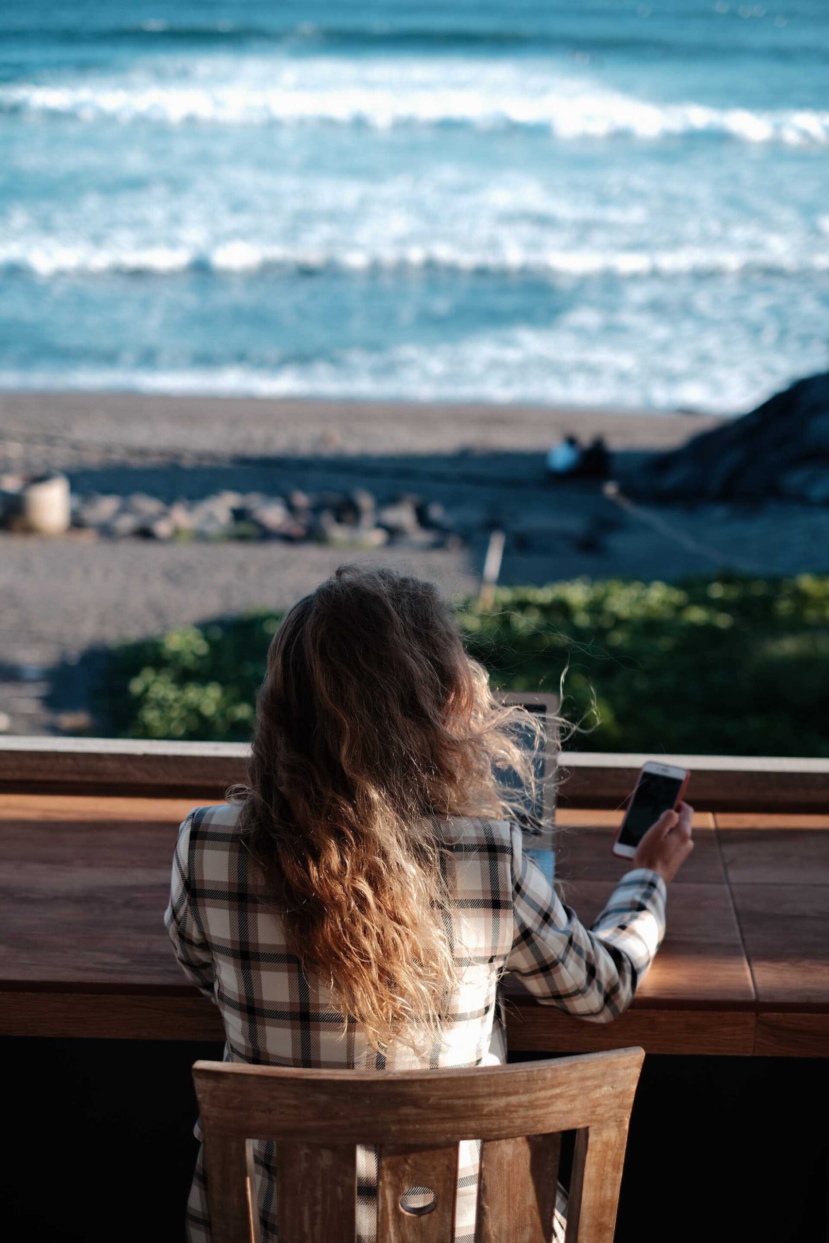 Woman looking at phone, considering a digital declutter