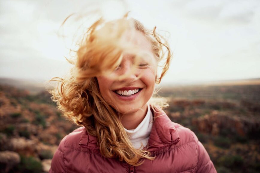 Woman smiling on a windy Fall day